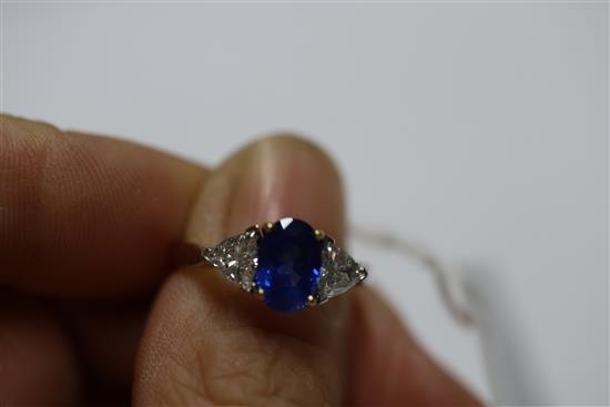 A modern 18ct white gold sapphire and diamond three stone dress ring, size M.